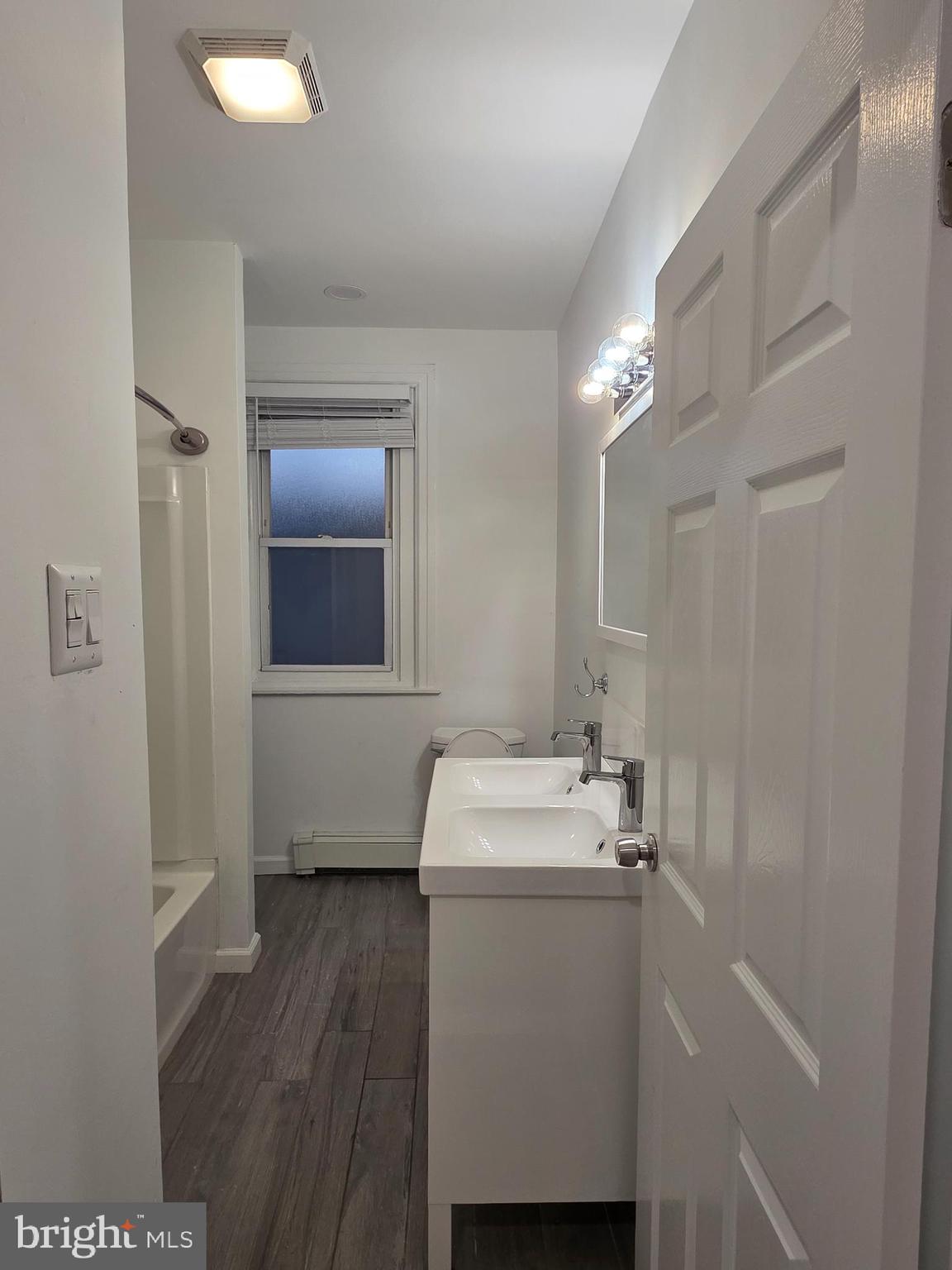 2715 East Ontario Street, Unit C Philadelphia, PA 19134 - Photo 14 of 32 a bathroom with a sink toilet and mirror