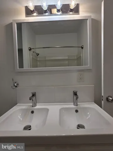 a bathroom with a sink and mirror