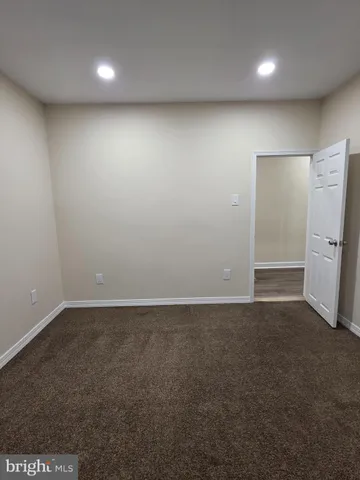 an empty room with a refrigerator