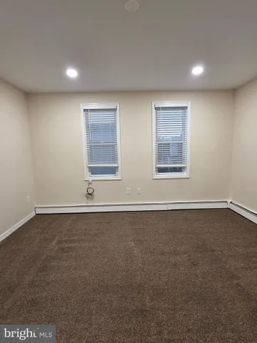 a view of an empty room and closet area