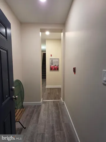 a view of hallway with wooden floor