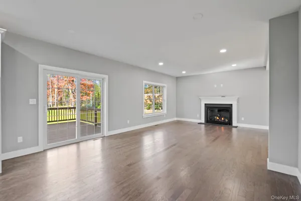 wooden floor in an empty room with a kitchen