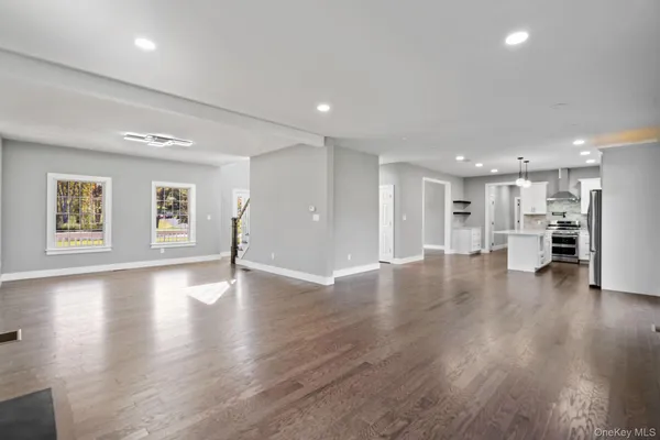 an empty room with wooden floor and fireplace