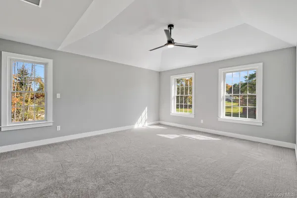 a view of a hallway with wooden floor and stairs