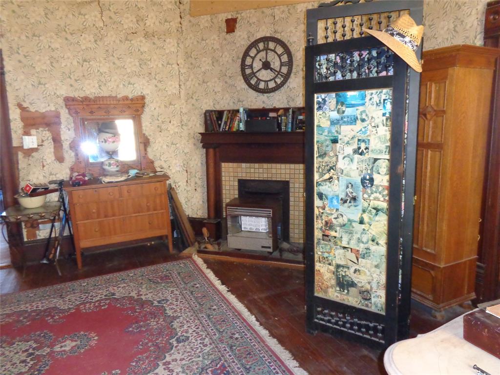 506 South 3rd Street Grandview, TX 76050 - Photo 11 of 39 a living room with furniture and a fireplace