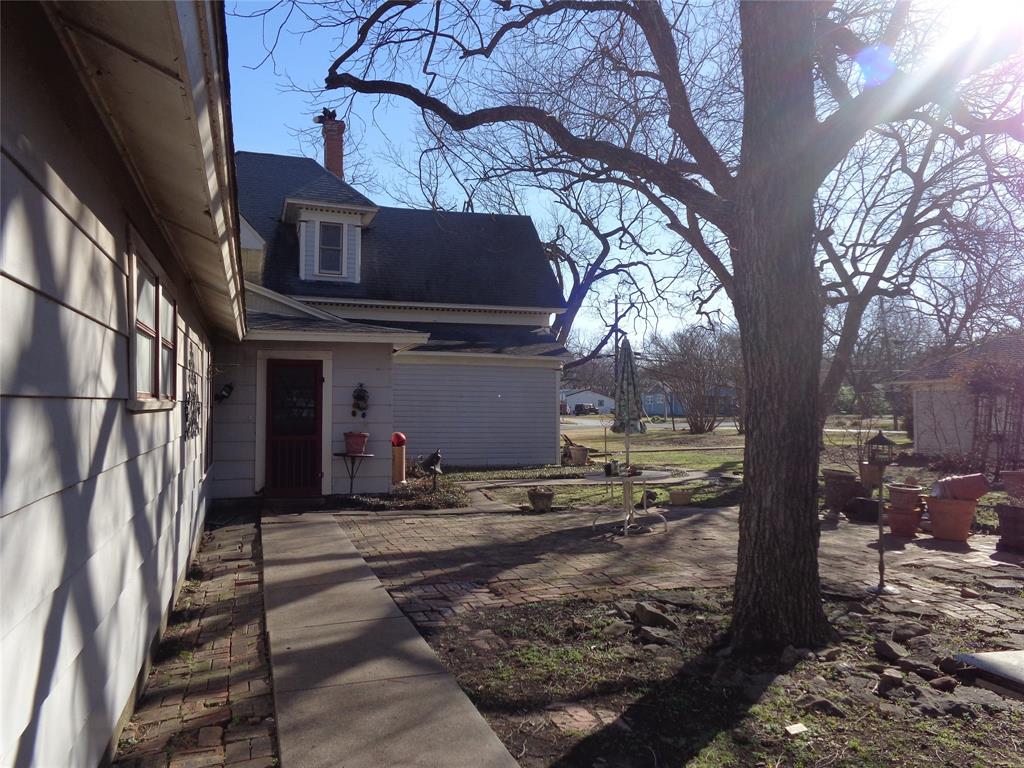 506 South 3rd Street Grandview, TX 76050 - Photo 29 of 39 a view of a house with a tree