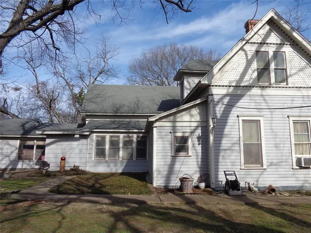 a view of a house with backyard porch and sitting area