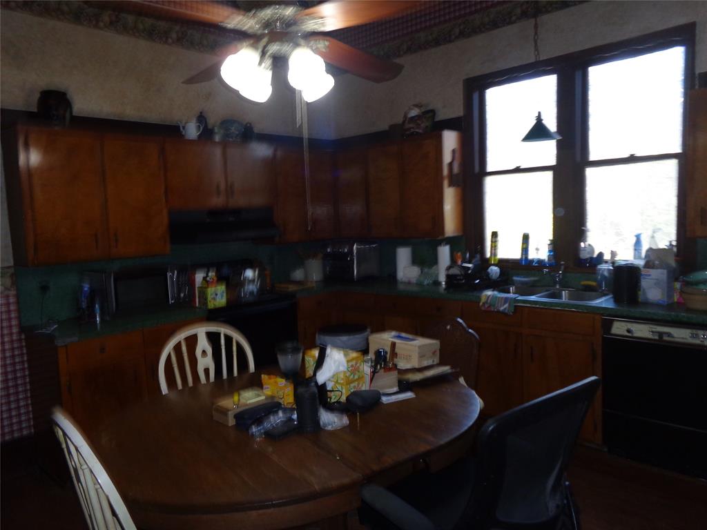 506 South 3rd Street Grandview, TX 76050 - Photo 5 of 39 a kitchen with granite countertop a dining table chairs and a stove