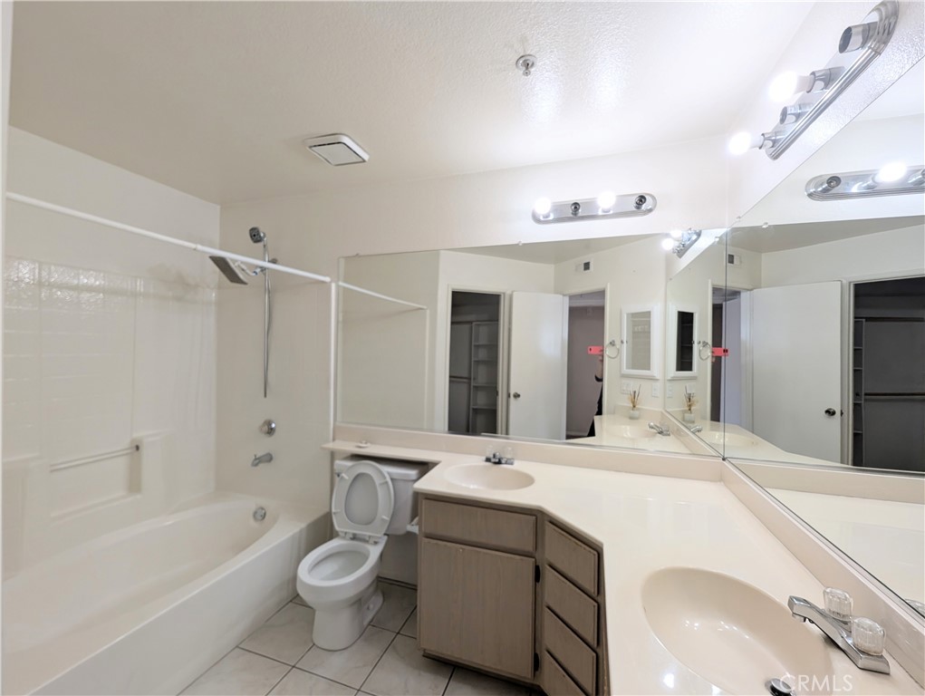 13133 Le Parc, Unit 1009 Chino Hills, CA 91709 - Photo 16 of 21 a bathroom with a double vanity sink toilet mirror and bathtub