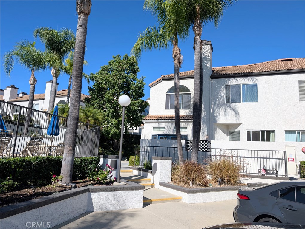 13133 Le Parc, Unit 1009 Chino Hills, CA 91709 - Photo 2 of 21 a front view of a house with tree s