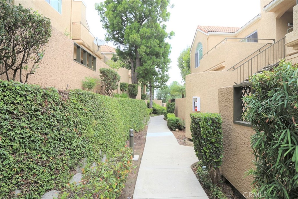 13133 Le Parc, Unit 1009 Chino Hills, CA 91709 - Photo 21 of 21 a view of a pathway with house on both side