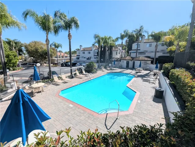 a swimming pool with outdoor seating and yard