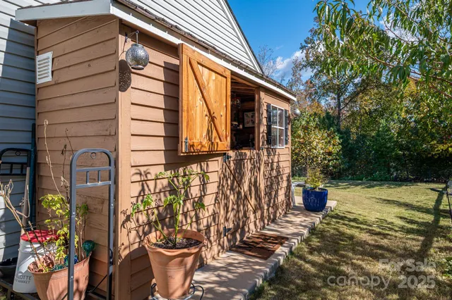 a view of a back yard of the house and a chair