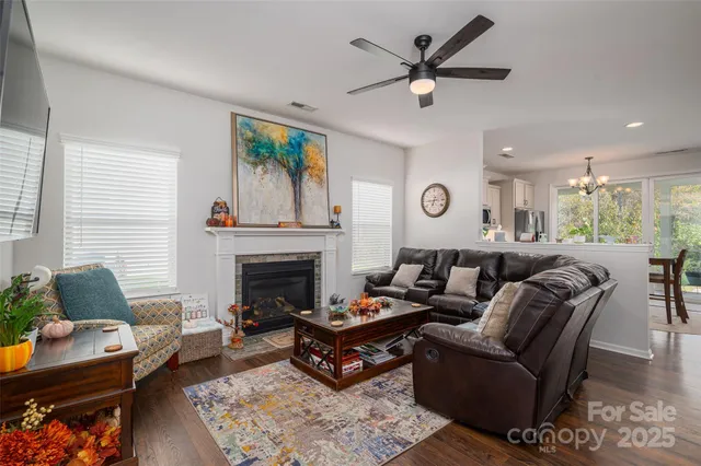 a living room with furniture a flat screen tv and a fireplace