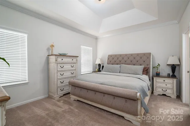 a bedroom with a bed and a flat screen television