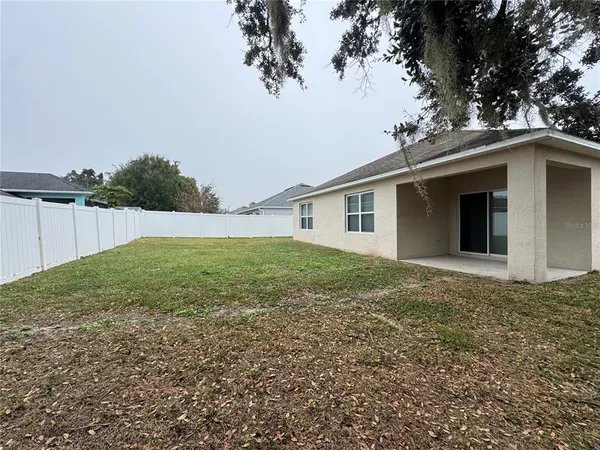 a view of backyard of house and green space