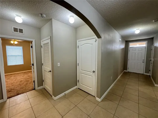 a view of a hallway with wooden shelves