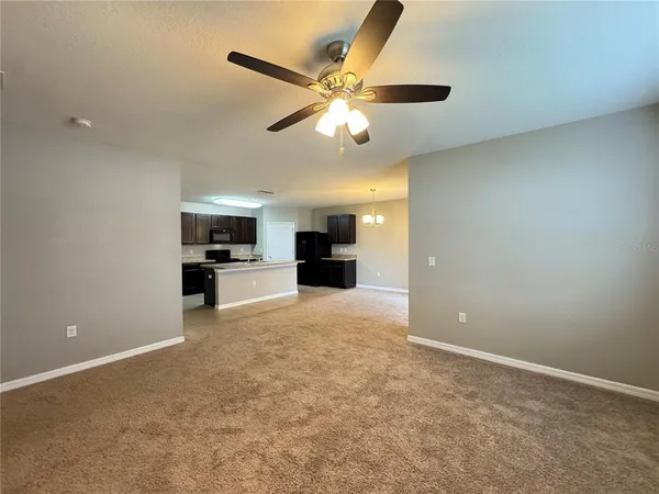an empty room with furniture and windows