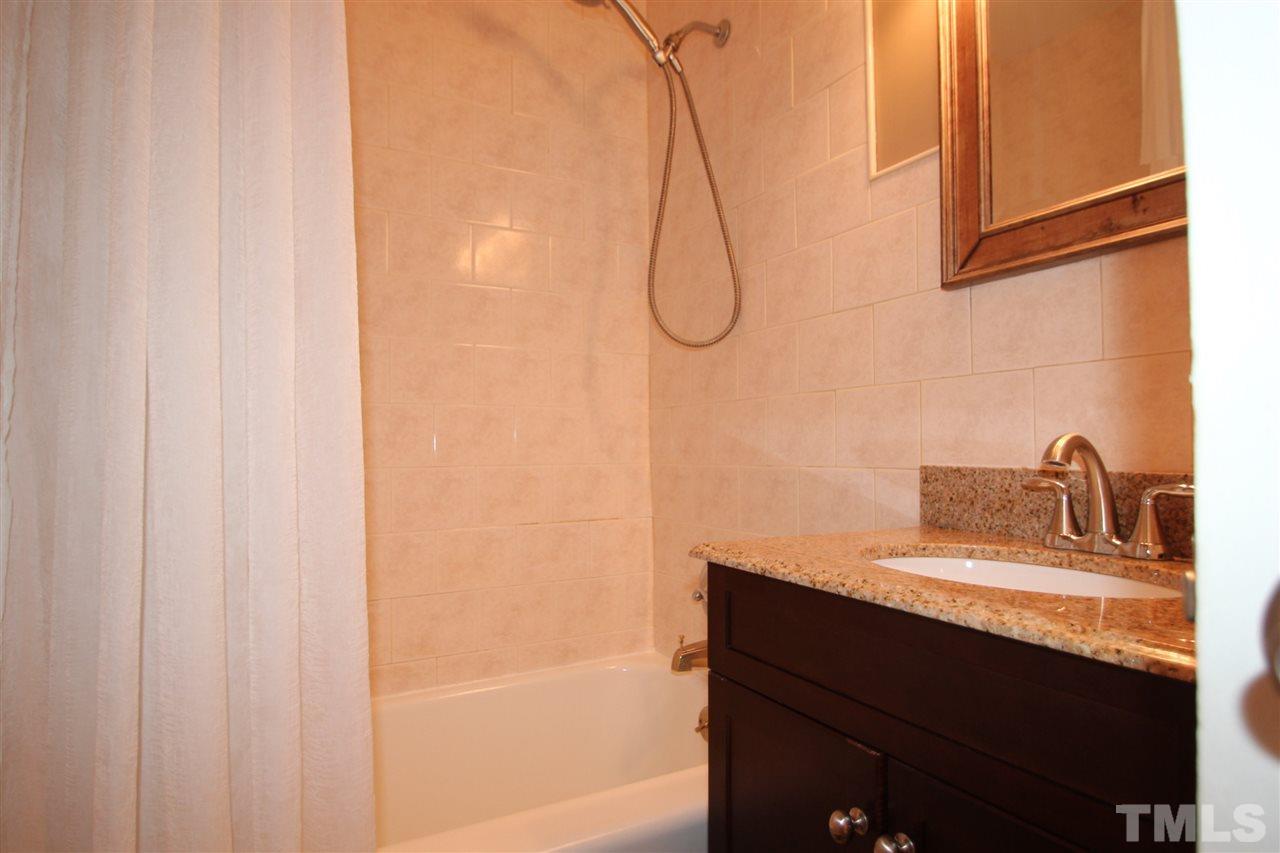 2042 Wake Forest Road Raleigh, NC 27608 - Photo 14 of 17 Bathroom with tile floor, ceramic tile shower and updated vanity