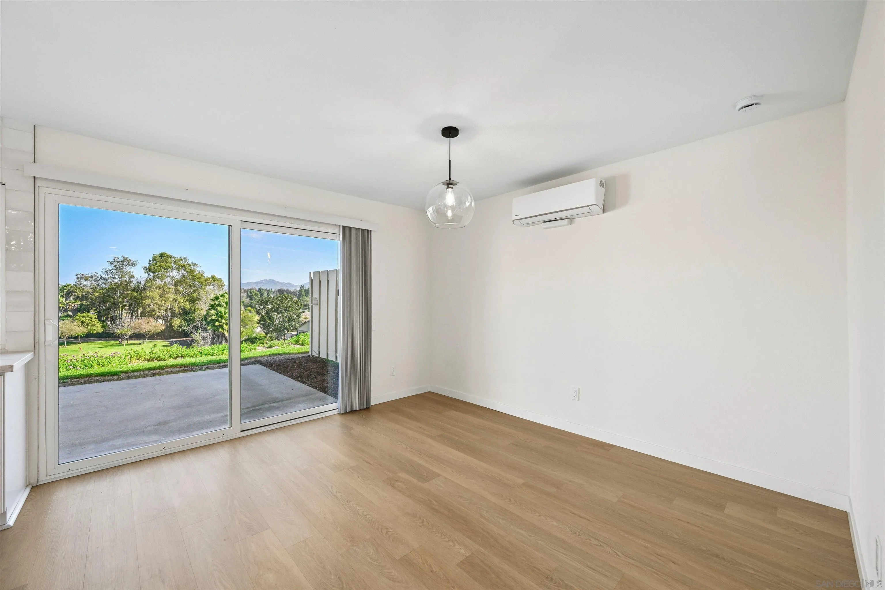 11218 Poblado Road San Diego, CA 92127 - Photo 15 of 35 an empty room with wooden floor and windows