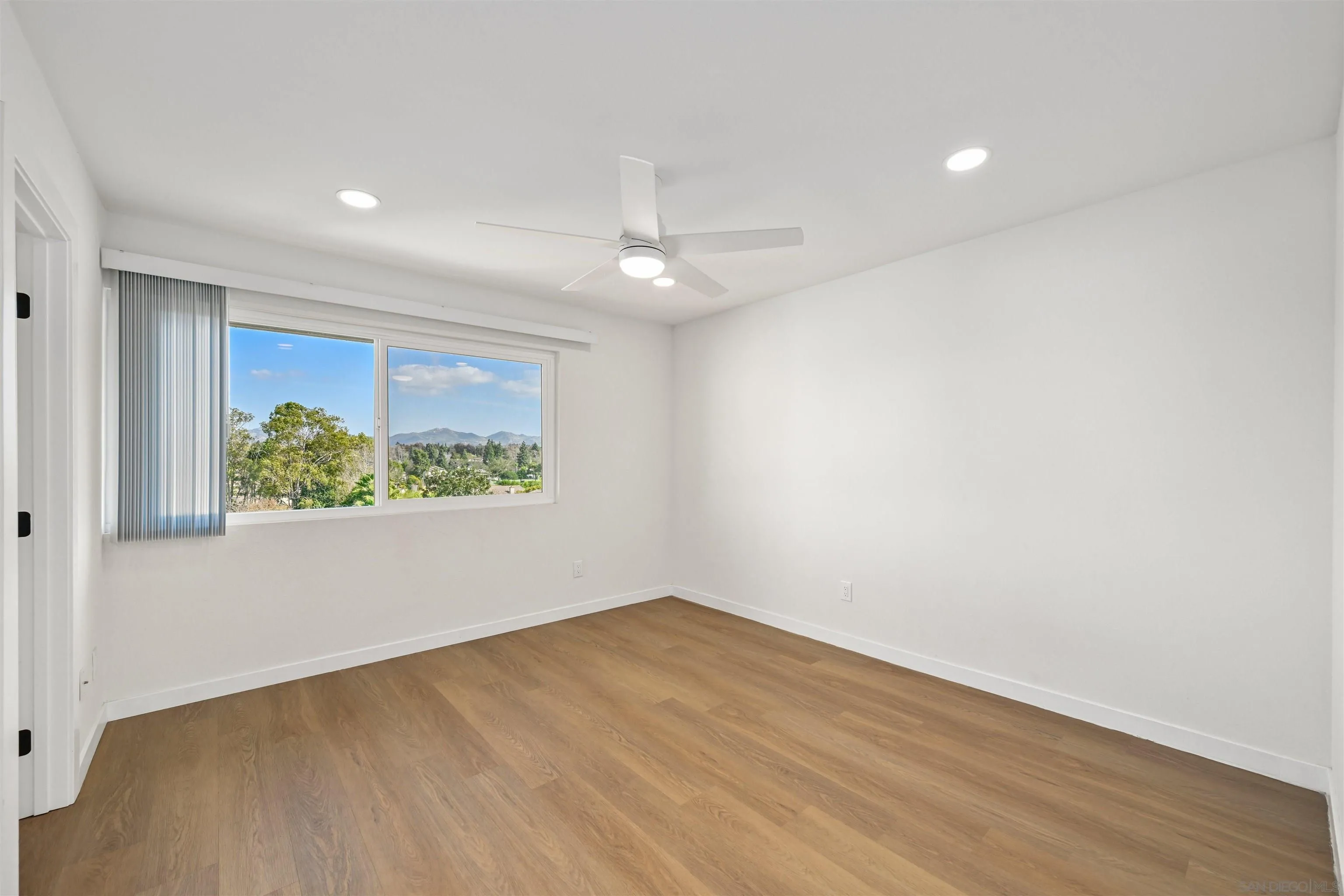11218 Poblado Road San Diego, CA 92127 - Photo 18 of 35 wooden floor in an empty room with a window