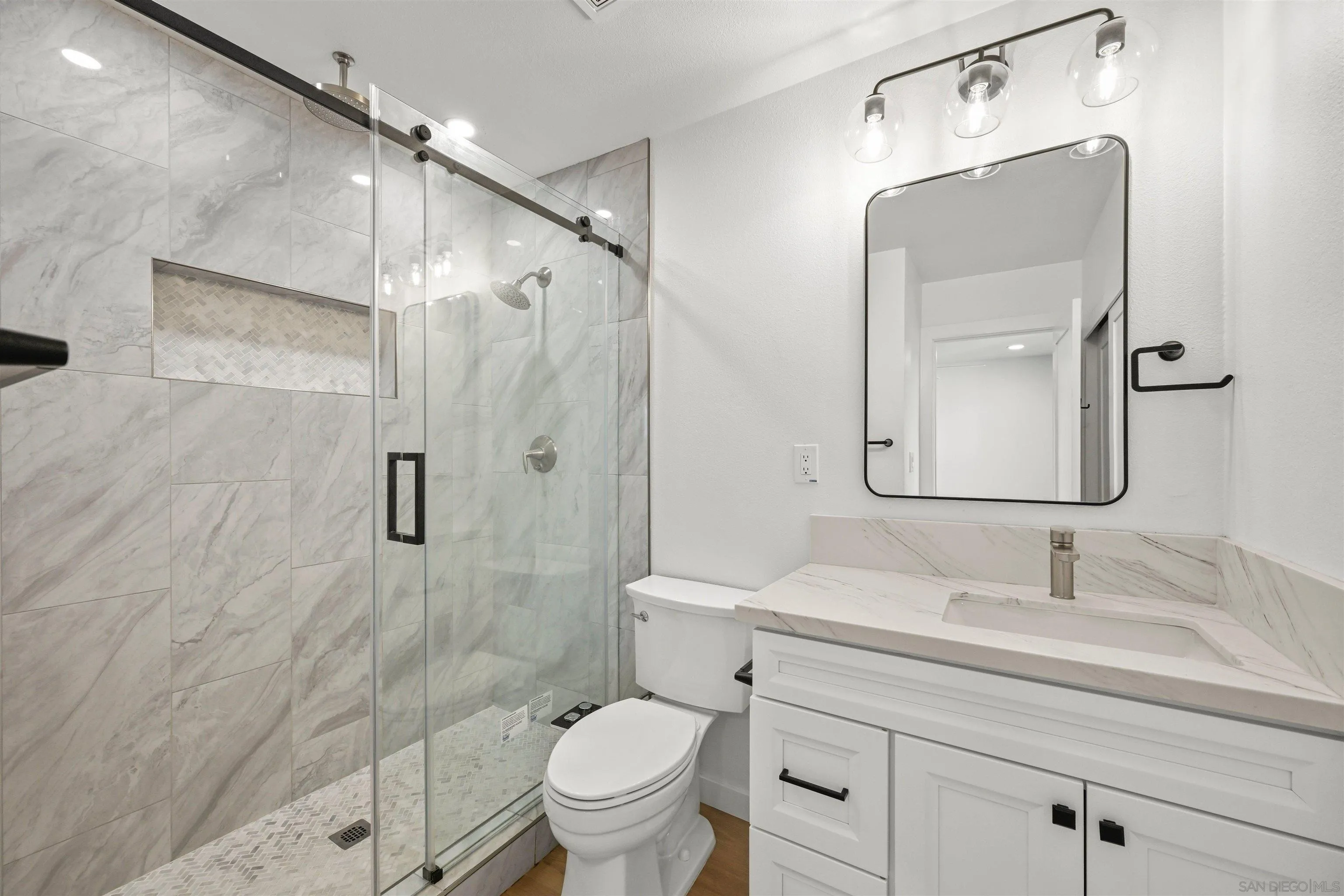 11218 Poblado Road San Diego, CA 92127 - Photo 19 of 35 a bathroom with a sink toilet and shower