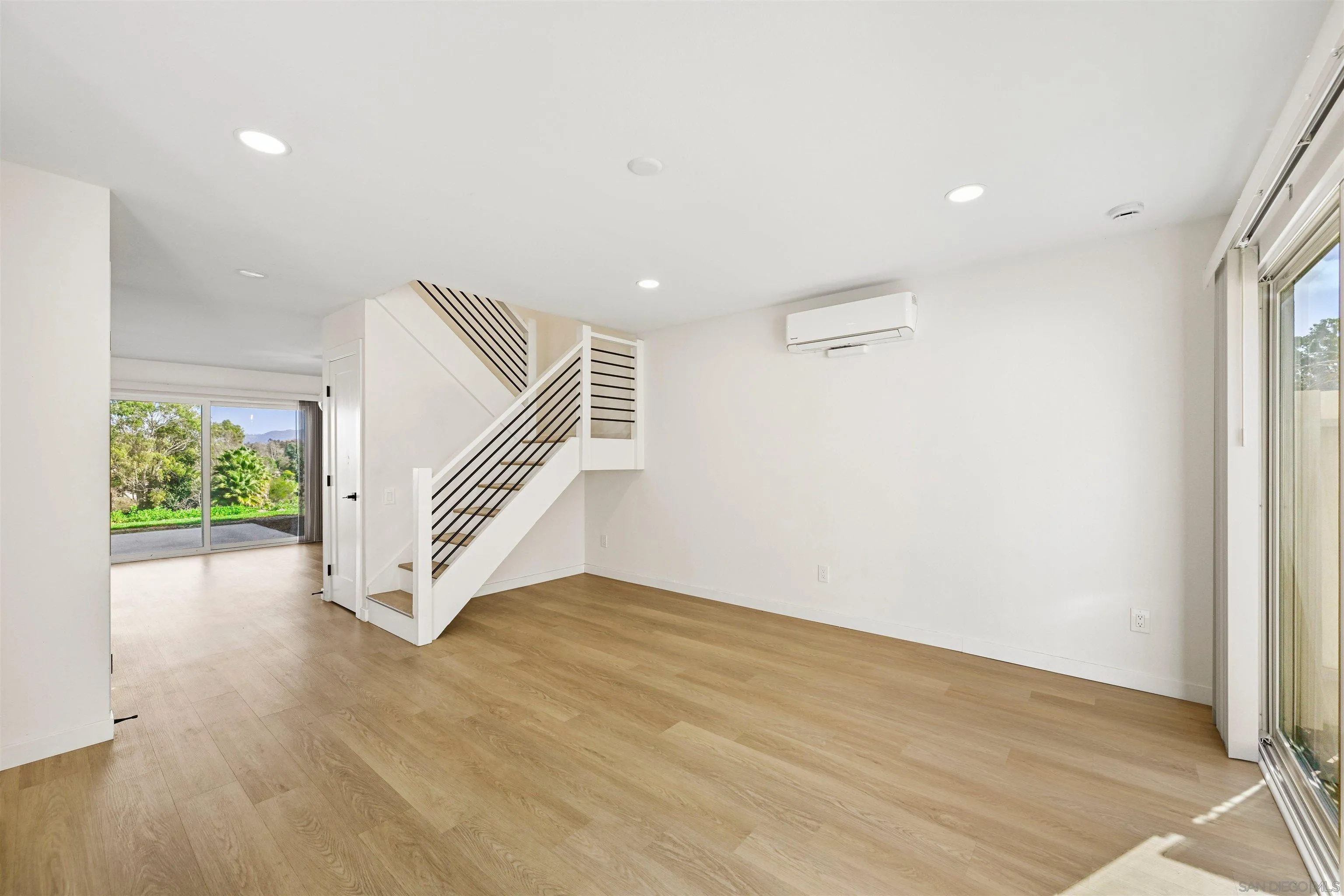 11218 Poblado Road San Diego, CA 92127 - Photo 2 of 35 wooden floor in an empty room with a window