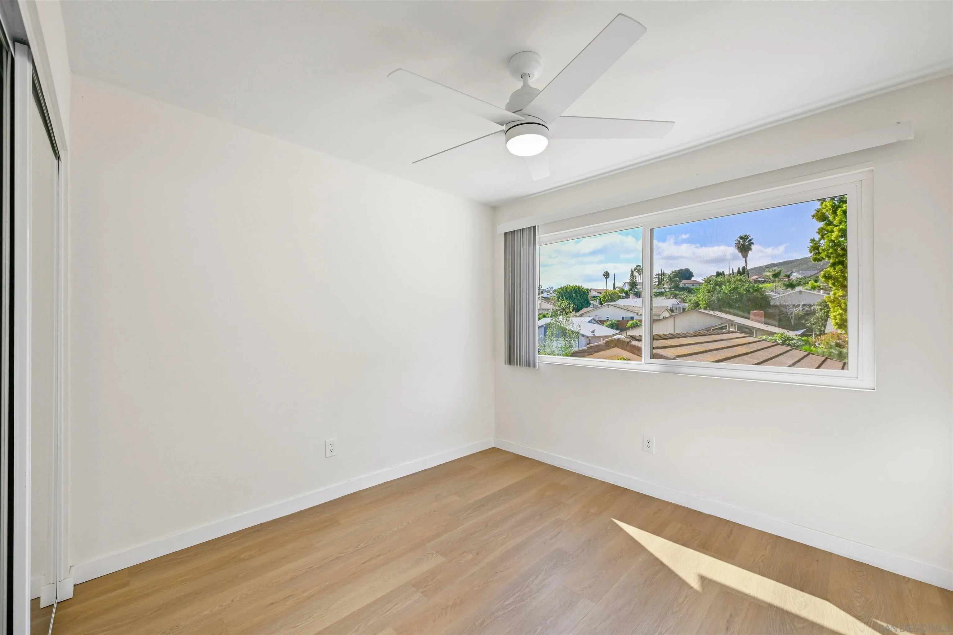 11218 Poblado Road San Diego, CA 92127 - Photo 25 of 35 an empty room with window and wooden floor
