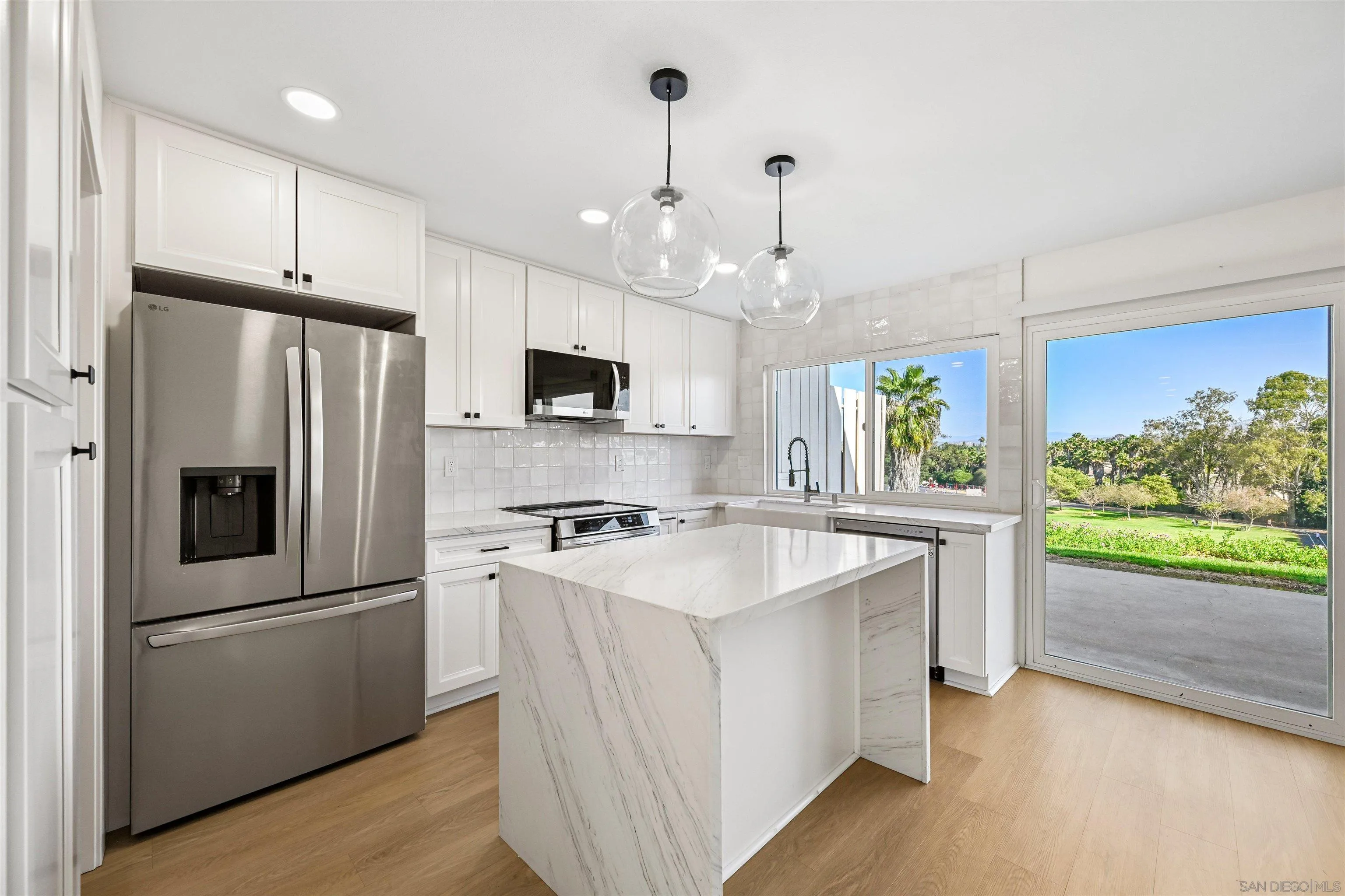 11218 Poblado Road San Diego, CA 92127 - Photo 10 of 35 a kitchen with stainless steel appliances a stove a sink a refrigerator and a center island