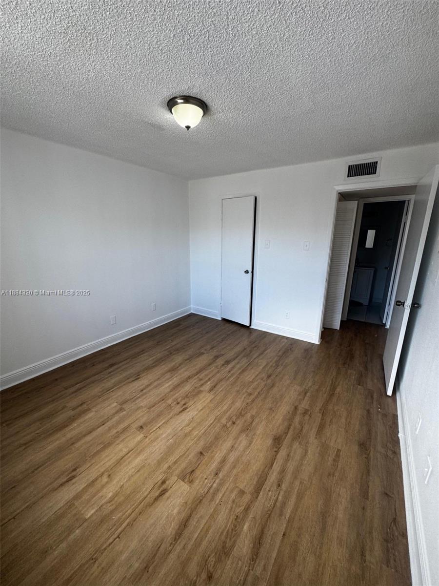 15040 Southwest 103rd Lane, Unit 3202 Miami, FL 33196 - Photo 11 of 14 a view of empty room with wooden floor
