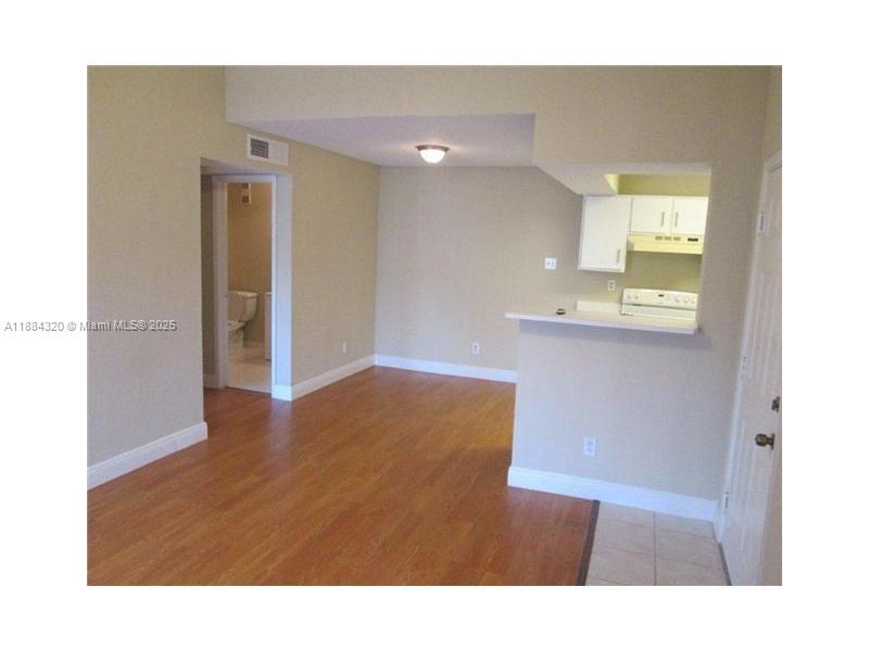 15040 Southwest 103rd Lane, Unit 3202 Miami, FL 33196 - Photo 3 of 14 a bathroom with a sink a mirror and a toilet