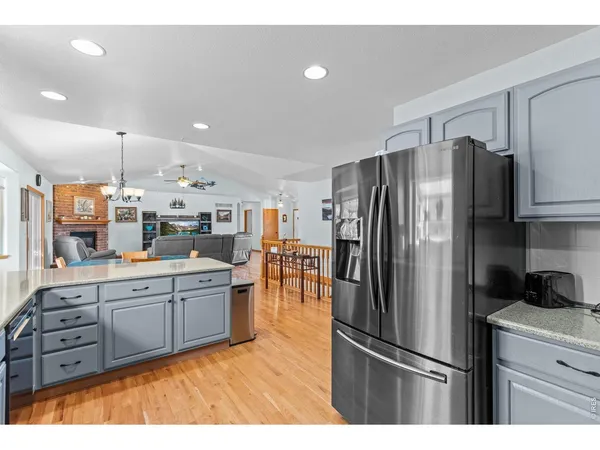 a kitchen with stainless steel appliances a refrigerator sink and microwave