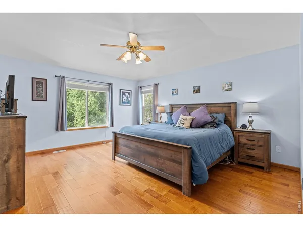 a bedroom with a bed and a television