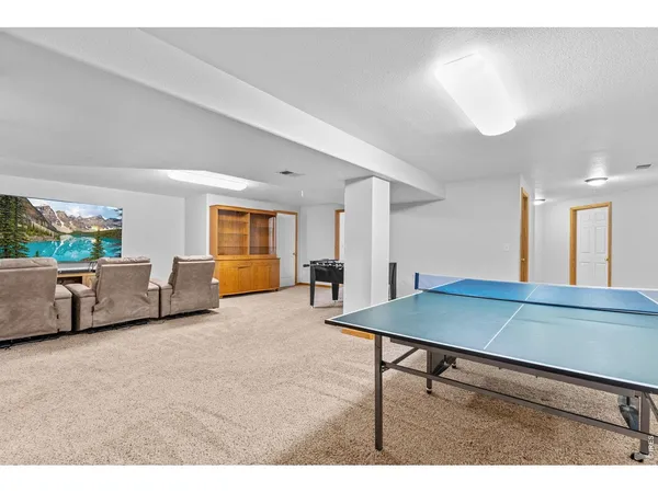 a room with furniture pool table and windows