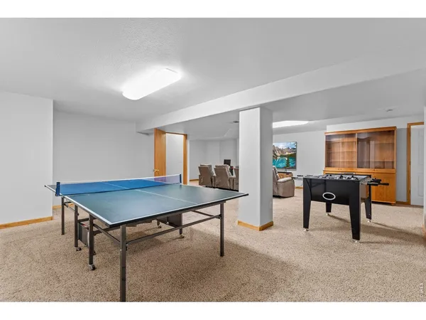 a living room with furniture a flat screen tv and a dresser