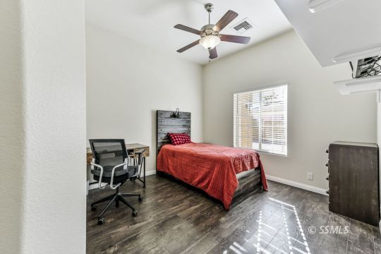 1213 Carolyn Street Ridgecrest, CA 93555 - Photo 29 of 50 a bed sitting in a bedroom next to a window