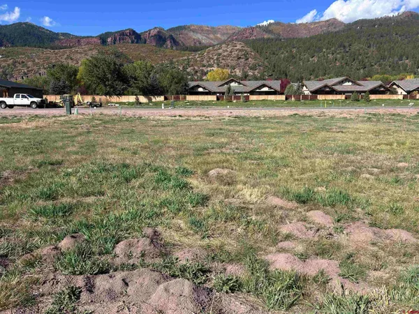 a view of a town with mountains in the background