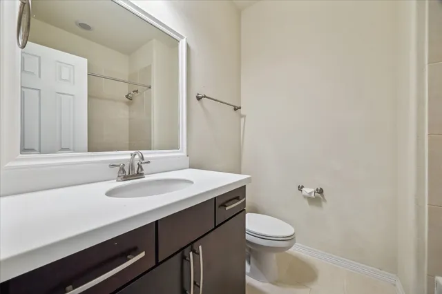 a bathroom with a sink a toilet and mirror