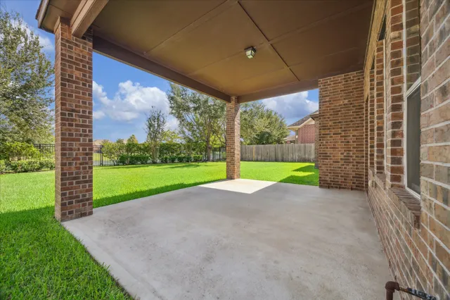 a view of a house with backyard and porch