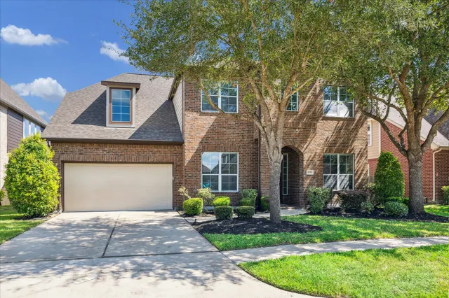 a front view of house with a garden