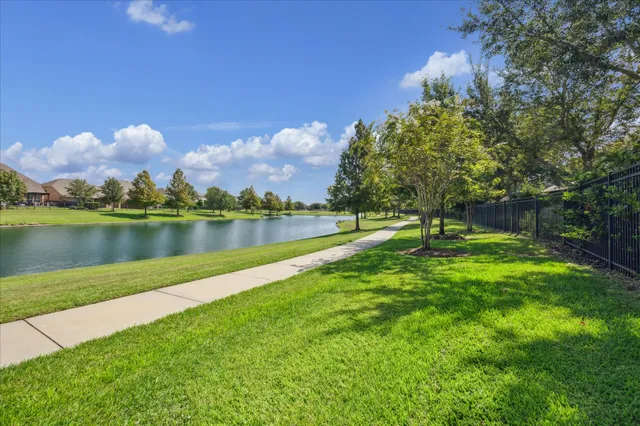 a view of a lake with houses in the back