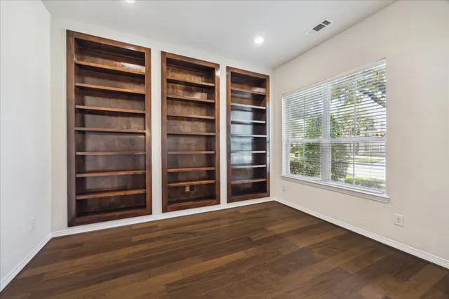 a view of wooden floor and windows in a room