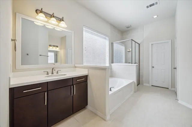 a bathroom with a double vanity sink and a mirror