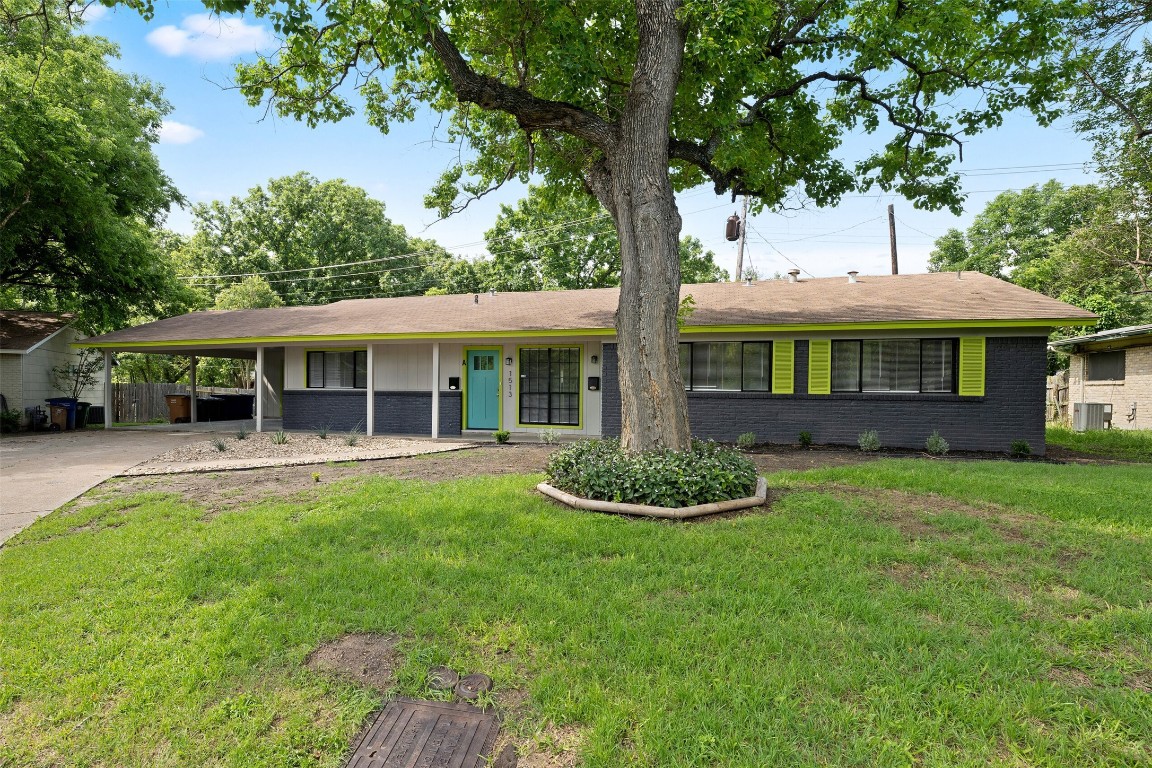 1513 Braes Ridge Drive, Unit A Austin, TX 78723 - Photo 1 of 1 a front view of a house with a yard table and chairs