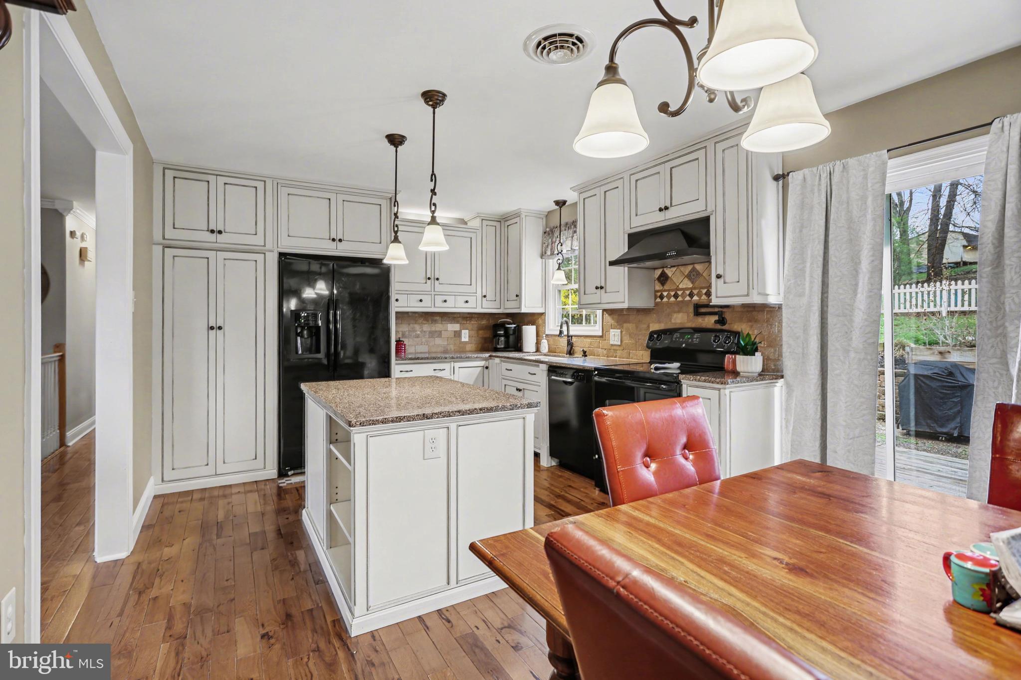 90 Eagle Lane Etters, PA 17319 - Photo 8 of 33 a kitchen with stainless steel appliances kitchen island granite countertop a refrigerator a stove top oven a sink dishwasher and white appliances with wooden floor