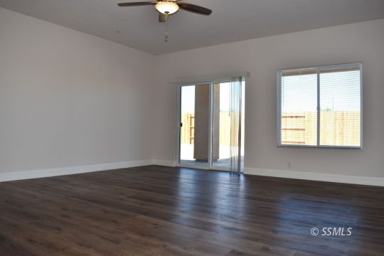 1319 South Farragut Street Ridgecrest, CA 93555 - Photo 10 of 33 an empty room with wooden floor and windows