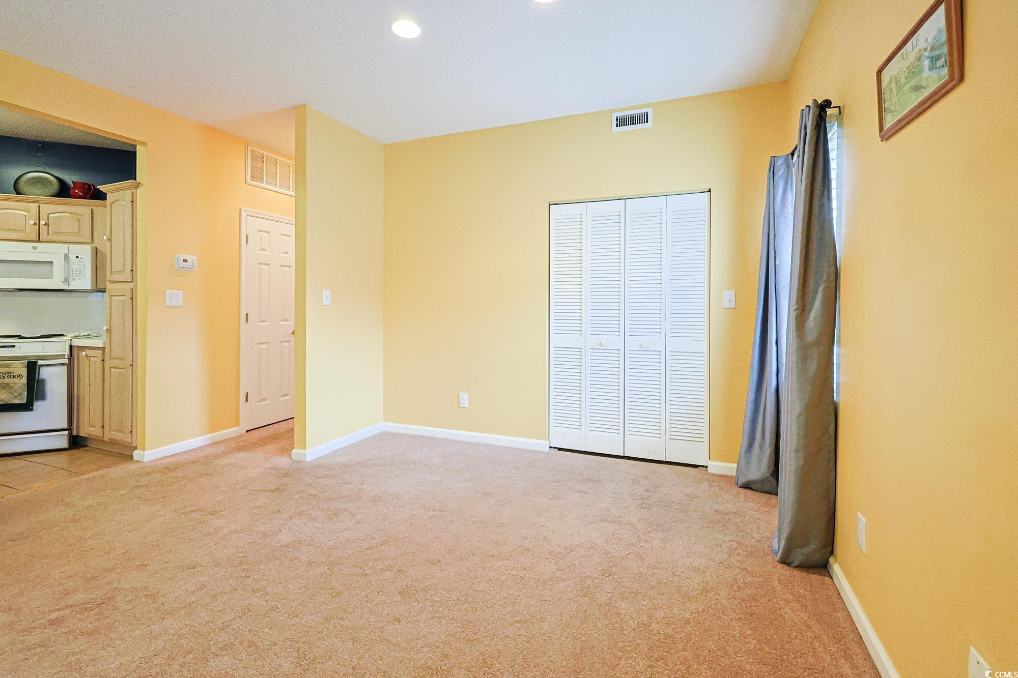 2302 Sweetwater Boulevard, Unit 2302 Murrells Inlet, SC 29576 - Photo 6 of 24 Unfurnished bedroom featuring light carpet, a closet, and recessed lighting
