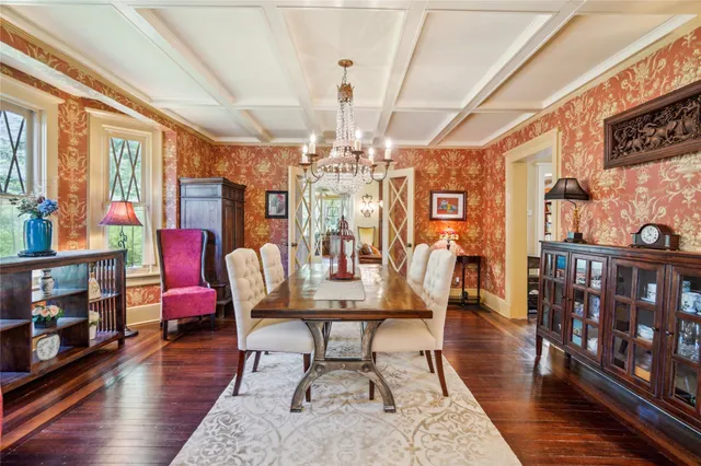 a view of a dining room with furniture a chandelier and wooden floor