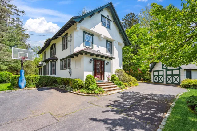 a front view of a house with a yard and outdoor seating