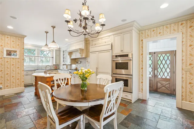 a view of a dining room with furniture and chandelier